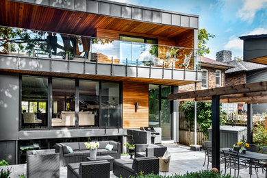Inspiration for a gray two-story flat roof remodel in Toronto