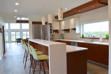 Eat-in kitchen - large modern u-shaped dark wood floor eat-in kitchen idea in Boston with a single-bowl sink, flat-panel cabinets, dark wood cabinets, quartz countertops, white backsplash, mosaic tile backsplash, stainless steel appliances and an island