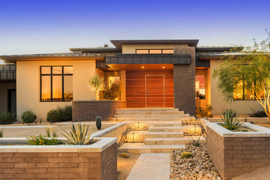 This is an example of a mid-sized contemporary beige exterior in Phoenix with mixed siding.