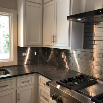 White Kitchens with Stainless Steel Backsplash
