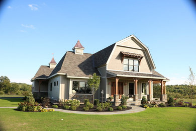 Mid-sized cottage beige two-story concrete fiberboard exterior home idea in Boston with a gambrel roof