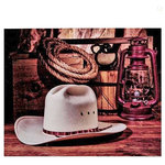 Giftcraft - "Daddy's Straw Hat" Canvas Print, 19.5"x15.5" - Sometimes simplicity says it better than a complex design.  This canvas print featuring a straw hat, lantern and rope measures 19 ½” wide and 15 ½” tall.  The rich brown hues of the wooden elements in the photograph add diversity and depth that will compliment any western décor.  The print hangs by an opening on the top and back of the frame.  This is lovely piece to hang in an entry way by a hall tree or over a desk in a den.  Pair with an old rope or bridle for added charm.