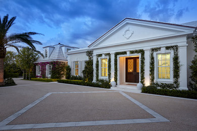 Traditional one-storey stucco white house exterior in Miami.