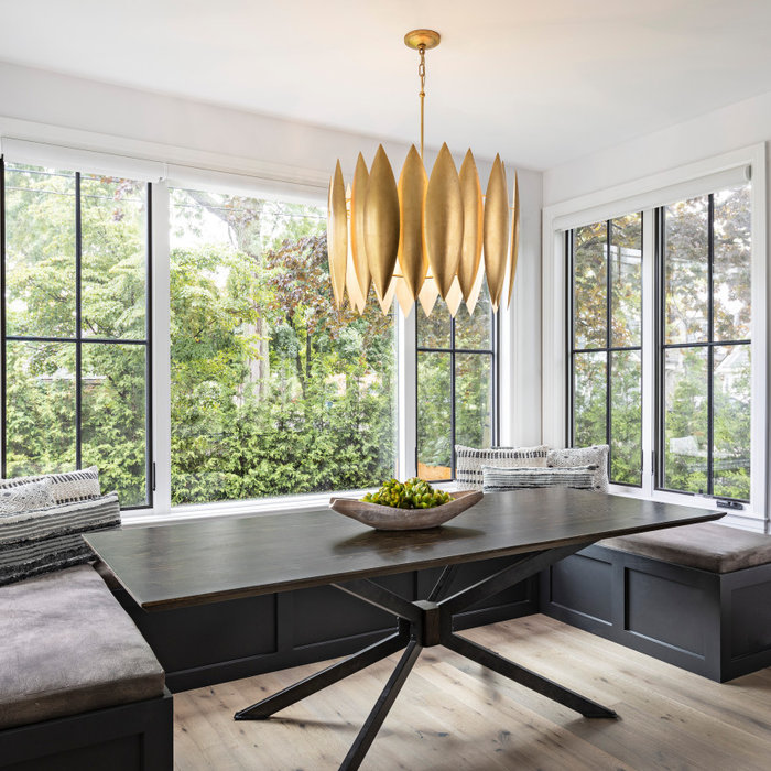 When presented with the overall layout of the kitchen, this dining space called out for more interest than just your standard table. We chose to make a statement with a custom three-sided seated banqu