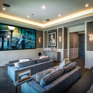Inspiration for a transitional enclosed carpeted and gray floor home theater remodel in Los Angeles with gray walls and a wall-mounted tv