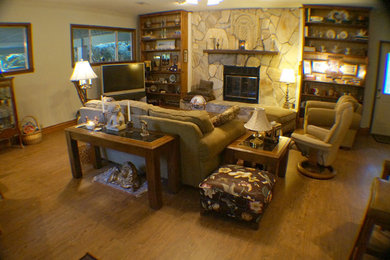 Family room - mid-sized 1960s enclosed light wood floor and brown floor family room idea in Miami with white walls, a standard fireplace, a stone fireplace and a tv stand