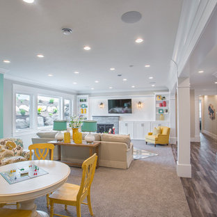 This is an example of a medium sized classic look-out basement in Salt Lake City with beige walls, dark hardwood flooring, a standard fireplace, a stone fireplace surround and brown floors.