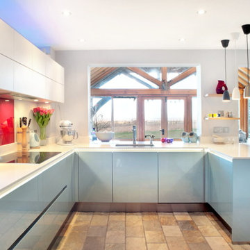 Contemporary platinum blue and white kitchen with a garden view