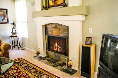 Living room - mid-sized modern carpeted living room idea in Denver with a standard fireplace and a stone fireplace