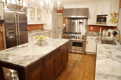 Inspiration for a large contemporary u-shaped open concept kitchen remodel in St Louis with shaker cabinets, dark wood cabinets, marble countertops and an island