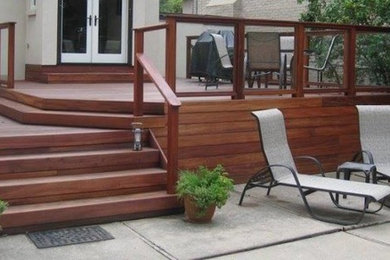 Mid-sized transitional backyard deck photo in Seattle with no cover