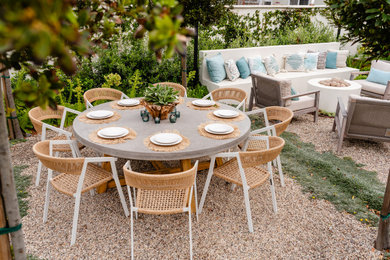Mid-sized trendy backyard gravel patio photo in Orange County with a fire pit