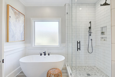 Inspiration for a mid-sized modern master white tile and ceramic tile wood-look tile floor, brown floor, double-sink and wainscoting bathroom remodel in Other with white cabinets, a two-piece toilet, gray walls, an undermount sink, quartz countertops, a hinged shower door, white countertops and a built-in vanity