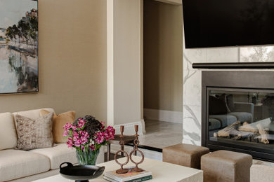 Example of a mid-sized transitional enclosed beige floor living room design in Toronto with beige walls, a standard fireplace, a tile fireplace and a wall-mounted tv