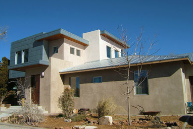 Design ideas for a large modern two-storey exterior in Albuquerque with mixed siding.