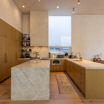 Modern Kitchen with Waterfall Island and Warm Wood Cabinetry
