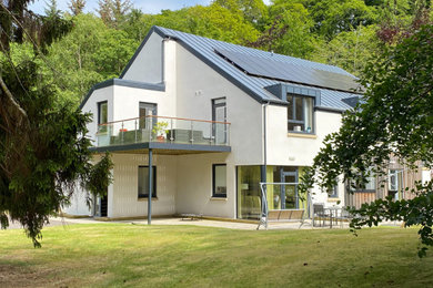 Inspiration for a white two floor render detached house in Other with a pitched roof and a grey roof.
