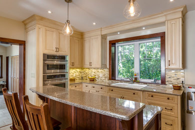 Inspiration for a mid-sized victorian u-shaped ceramic tile eat-in kitchen remodel in Toronto with recessed-panel cabinets, distressed cabinets, granite countertops, multicolored backsplash, matchstick tile backsplash, stainless steel appliances, an island and a drop-in sink