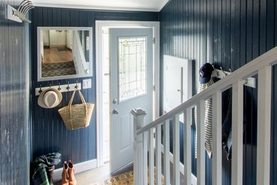 Example of a small transitional slate floor and gray floor entryway design in Toronto with blue walls and a white front door