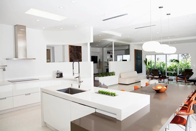 Enclosed kitchen - large modern u-shaped beige floor enclosed kitchen idea in San Diego with an undermount sink, flat-panel cabinets, white cabinets, an island, quartzite countertops and stainless steel appliances