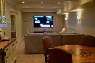 Mid-sized traditional enclosed home theatre in Boston with beige walls, carpet and a wall-mounted tv.