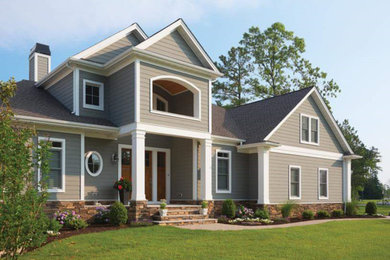 Mid-sized traditional gray two-story vinyl gable roof idea in Austin