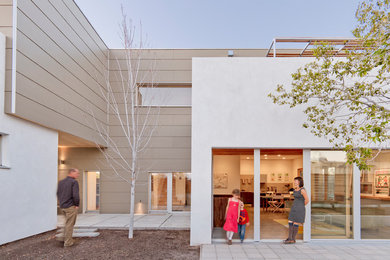 Inspiration for a mid-sized contemporary white two-story concrete fiberboard exterior home remodel in Albuquerque
