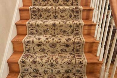 Mid-sized transitional wooden curved wood railing staircase photo in Philadelphia with wooden risers