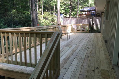 Example of a mid-sized country backyard deck design in Other
