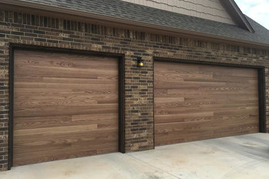 Garage - large contemporary attached three-car garage idea in Oklahoma City
