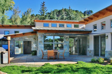 Example of a transitional home design design in Denver