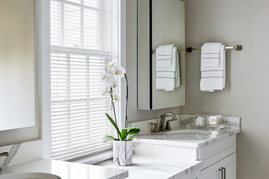 Bathroom - mid-sized traditional white tile and marble tile porcelain tile, gray floor and double-sink bathroom idea in Chicago with recessed-panel cabinets, white cabinets, a one-piece toilet, gray walls, an undermount sink, quartz countertops, a hinged shower door, white countertops and a built-in vanity