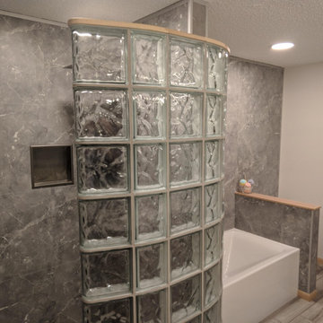 Glass Block Shower with a Curved Open Walk in Design