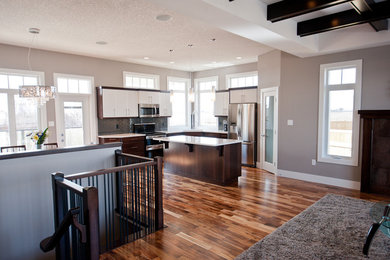 Inspiration for a mid-sized transitional formal and open concept medium tone wood floor living room remodel in Calgary with beige walls, a standard fireplace, a tile fireplace and a wall-mounted tv