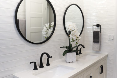 Inspiration for a large modern white tile and subway tile vinyl floor, gray floor and double-sink bathroom remodel in Toronto with shaker cabinets, white cabinets, a one-piece toilet, white walls, an undermount sink, marble countertops, white countertops, a niche and a freestanding vanity