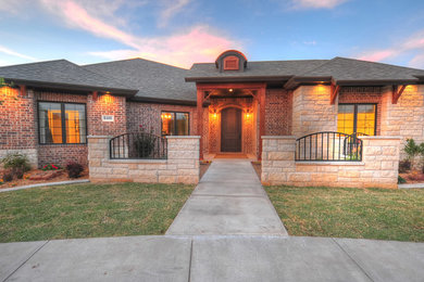 Inspiration for a mid-sized rustic beige one-story brick exterior home remodel in Austin with a hip roof