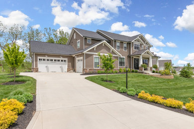 Large traditional brown two-story vinyl house exterior idea in Columbus with a hip roof and a shingle roof
