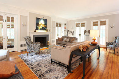 Living room - large traditional formal and enclosed medium tone wood floor and brown floor living room idea in Other with beige walls, a standard fireplace, a stone fireplace and no tv