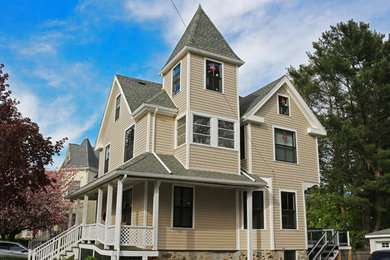 Example of a large ornate beige three-story mixed siding house exterior design in Boston with a hip roof and a shingle roof