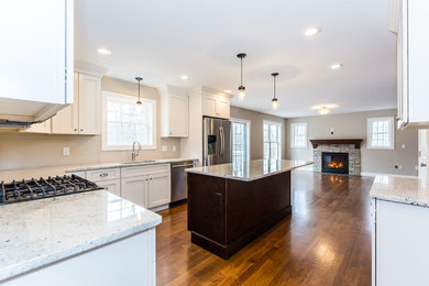Example of a large transitional dark wood floor eat-in kitchen design in Providence with an undermount sink, shaker cabinets, white cabinets, granite countertops, gray backsplash, stainless steel appliances and an island
