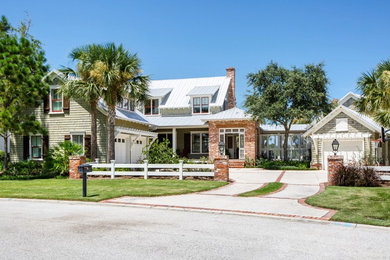 Coastal green two-story mixed siding exterior home idea in Jacksonville with a metal roof