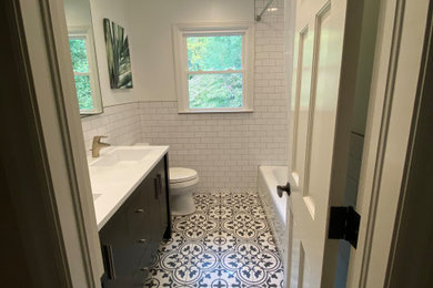 Small transitional kids' black and white tile and subway tile ceramic tile, white floor, double-sink and wainscoting bathroom photo in Atlanta with furniture-like cabinets, a one-piece toilet, an undermount sink, marble countertops, white countertops, a freestanding vanity, dark wood cabinets and white walls