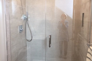 Photo of a small contemporary shower room bathroom in San Francisco with flat-panel cabinets, a walk-in shower, grey tiles, porcelain tiles, porcelain flooring, grey floors and a hinged door.