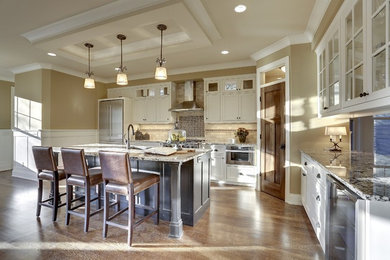 Transitional l-shaped medium tone wood floor eat-in kitchen photo in Minneapolis with a double-bowl sink, glass-front cabinets, white cabinets, granite countertops, beige backsplash, stone tile backsplash, stainless steel appliances and an island