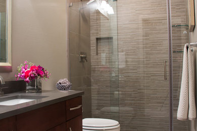 Mid-sized trendy 3/4 beige tile and stone tile ceramic tile alcove shower photo in Other with flat-panel cabinets, dark wood cabinets, a two-piece toilet, beige walls, an undermount sink, quartz countertops and gray countertops