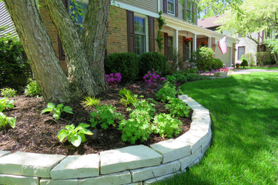Inspiration for a transitional front yard garden in Chicago with a retaining wall and brick pavers.