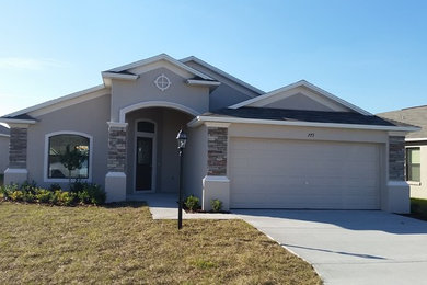 Mid-sized transitional gray one-story stucco exterior home photo in Orlando