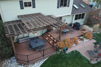 Deck - mid-sized traditional backyard deck idea in Denver with a pergola