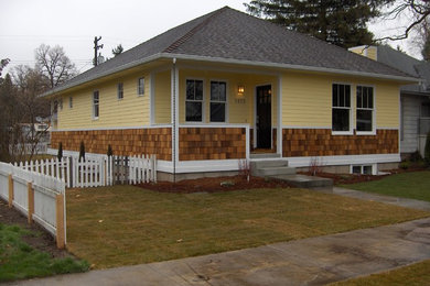 Example of a mid-sized classic yellow one-story mixed siding house exterior design in Boise with a hip roof and a shingle roof