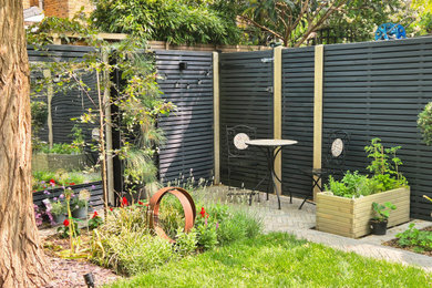 Photo of a small contemporary back garden seating in London.